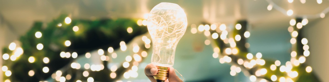 Hand with glowing lightbulb